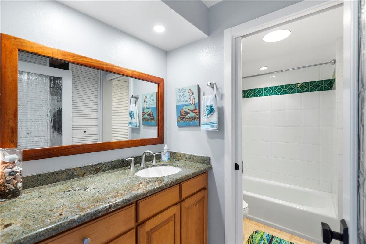 3601 Lower Honoapiilani Road, Unit 201 Lahaina, HI 96761 - Photo 20 of 37 a bathroom with a granite countertop sink and a mirror