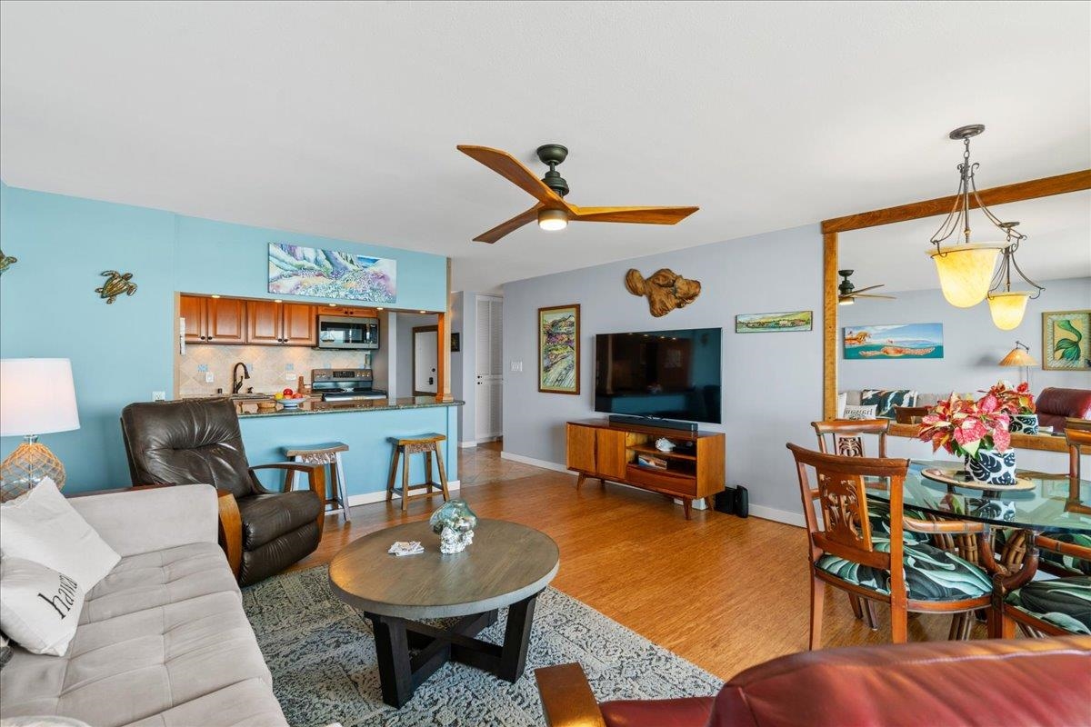 3601 Lower Honoapiilani Road, Unit 201 Lahaina, HI 96761 - Photo 22 of 37 a living room with furniture a flat screen tv and kitchen view