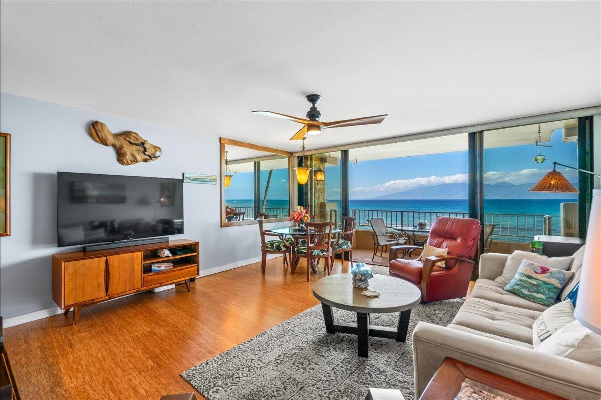 3601 Lower Honoapiilani Road, Unit 201 Lahaina, HI 96761 - Photo 5 of 37 a living room with furniture flat screen tv and a large window