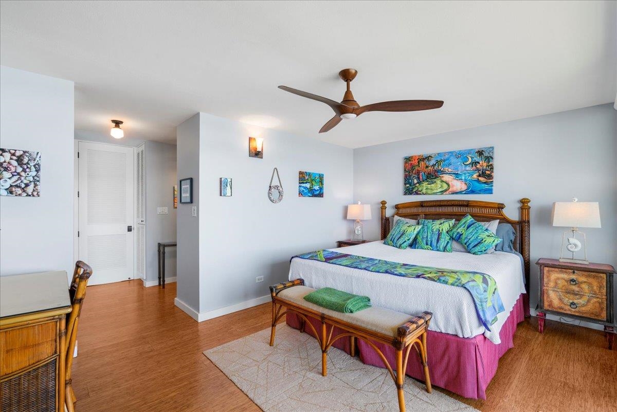 3601 Lower Honoapiilani Road, Unit 201 Lahaina, HI 96761 - Photo 8 of 37 a bedroom with a bed and a chandelier