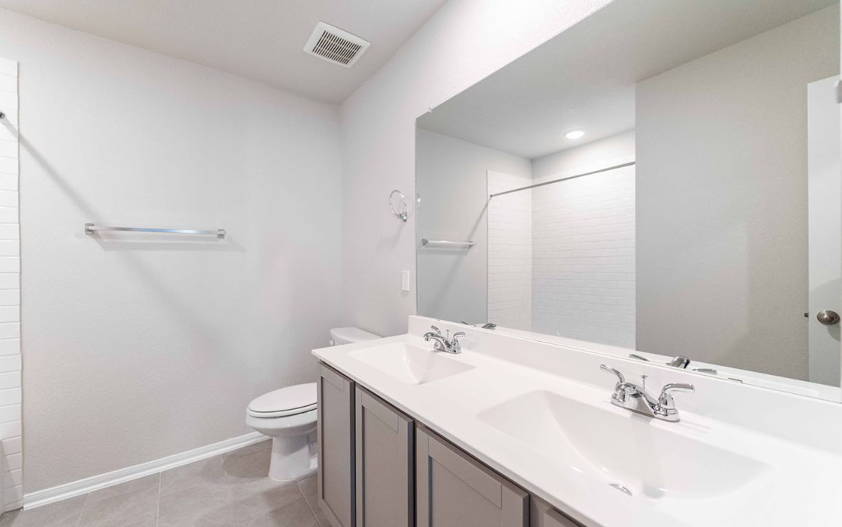 224 Denali Drive Kyle, TX 78640 - Photo 13 of 18 a bathroom with a sink toilet and shower