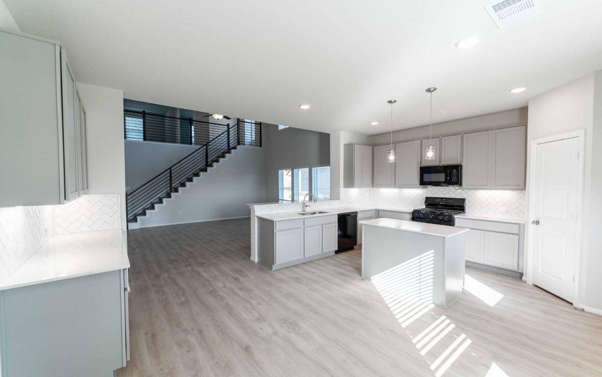 224 Denali Drive Kyle, TX 78640 - Photo 8 of 18 a kitchen with a sink stainless steel appliances and cabinets