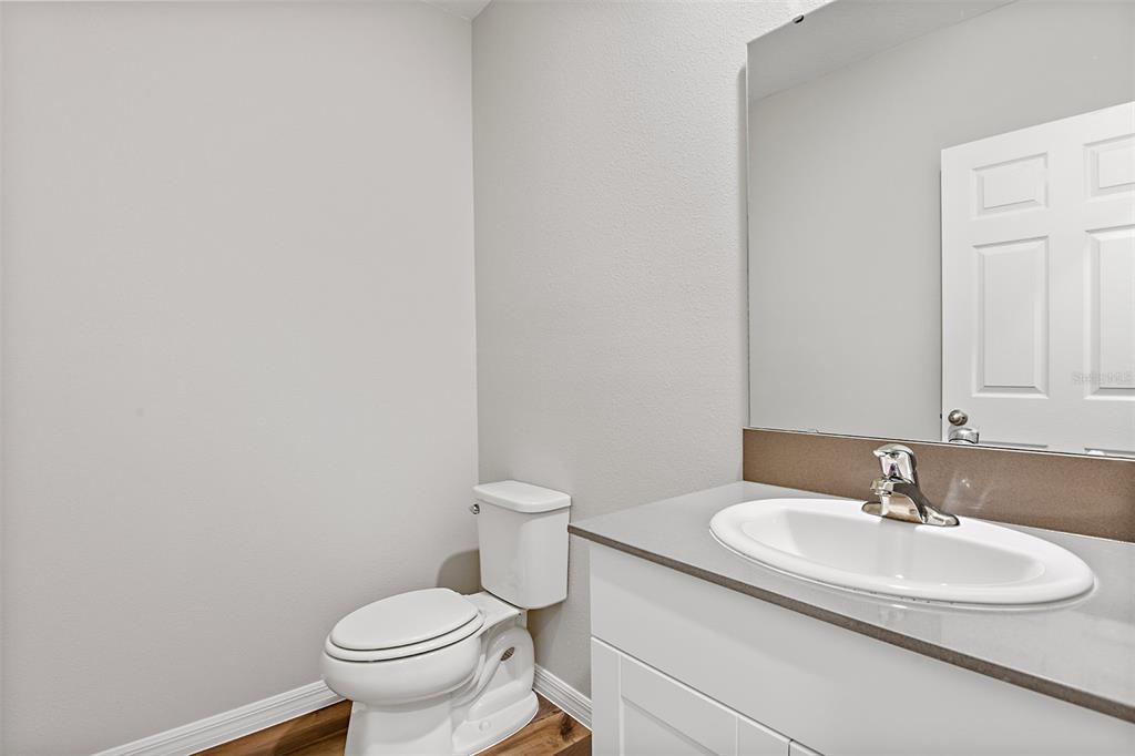 4385 Prairie Run Haines City, FL 33844 - Photo 12 of 25 a bathroom with a sink toilet and a mirror