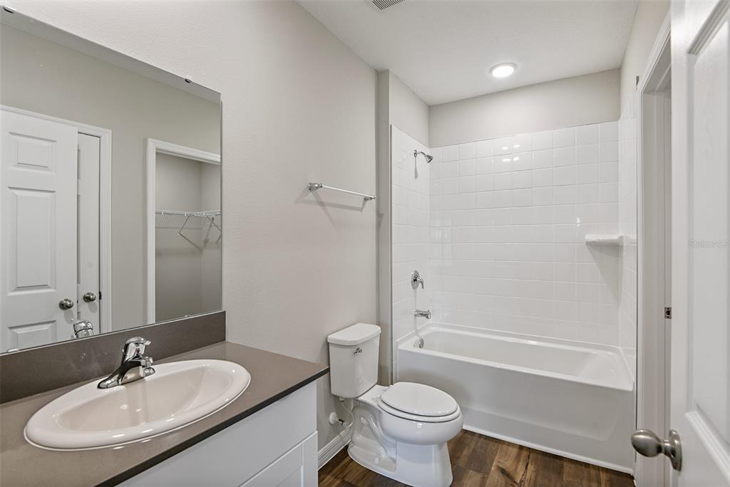 4385 Prairie Run Haines City, FL 33844 - Photo 13 of 25 a bathroom with a sink toilet and shower
