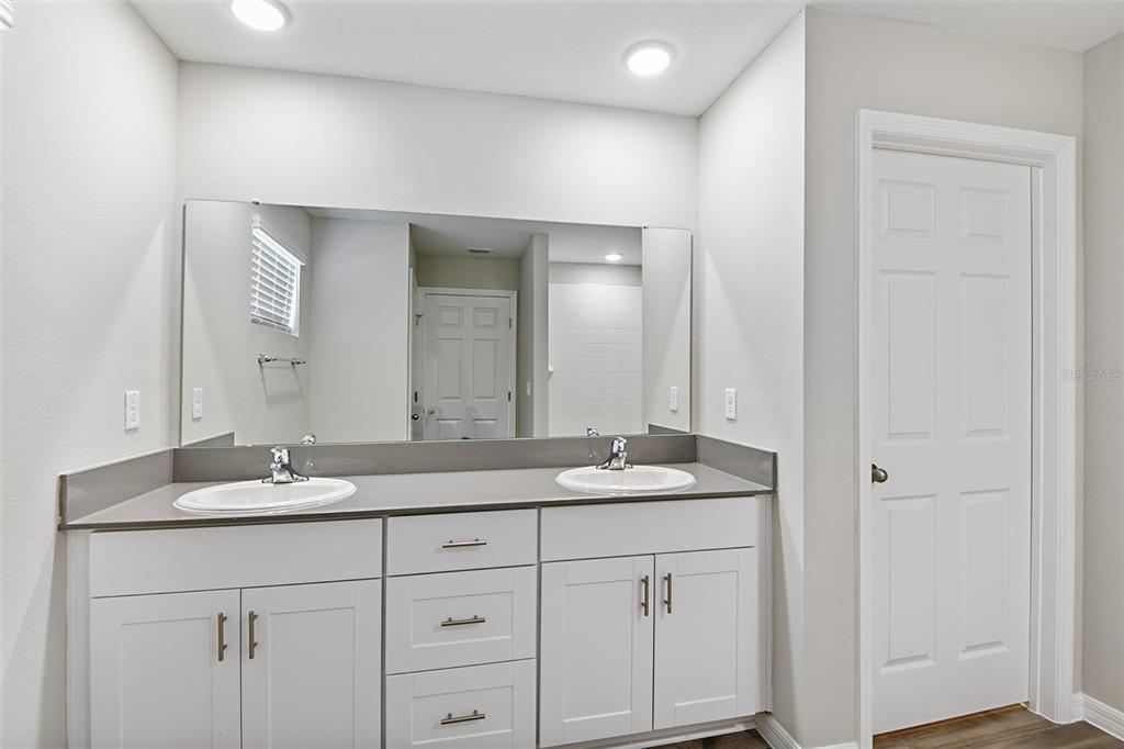 4385 Prairie Run Haines City, FL 33844 - Photo 23 of 25 a bathroom with a granite countertop sink and a mirror