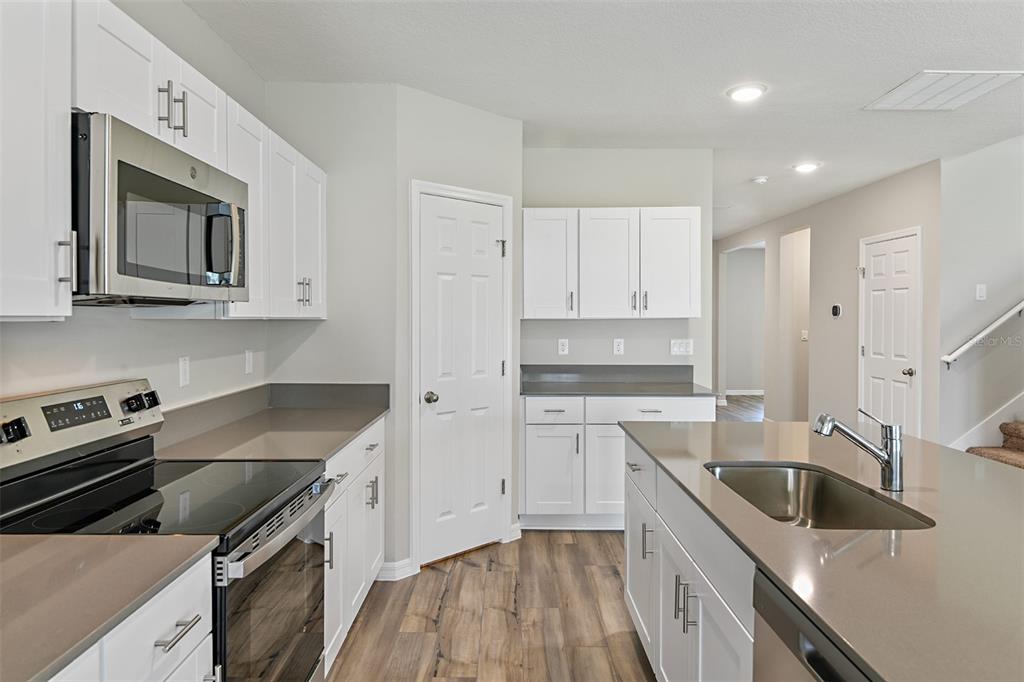 4385 Prairie Run Haines City, FL 33844 - Photo 3 of 25 a kitchen that has a sink and a stove