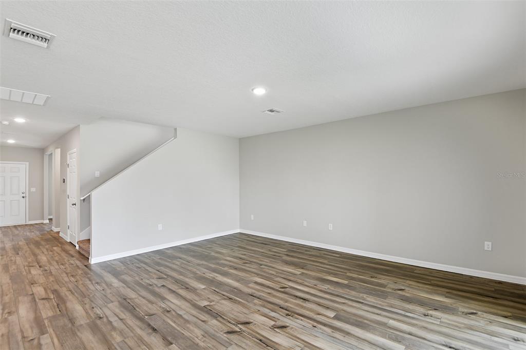 4385 Prairie Run Haines City, FL 33844 - Photo 7 of 25 a view of empty room with wooden floor