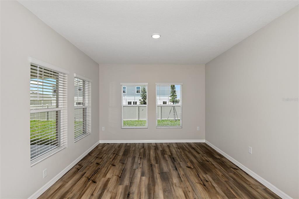 4385 Prairie Run Haines City, FL 33844 - Photo 8 of 25 a view of empty room with wooden floor and fan