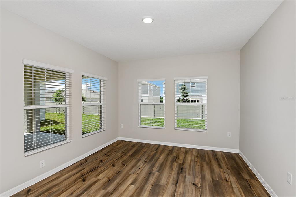 4385 Prairie Run Haines City, FL 33844 - Photo 9 of 25 a view of an empty room with wooden floor and a window