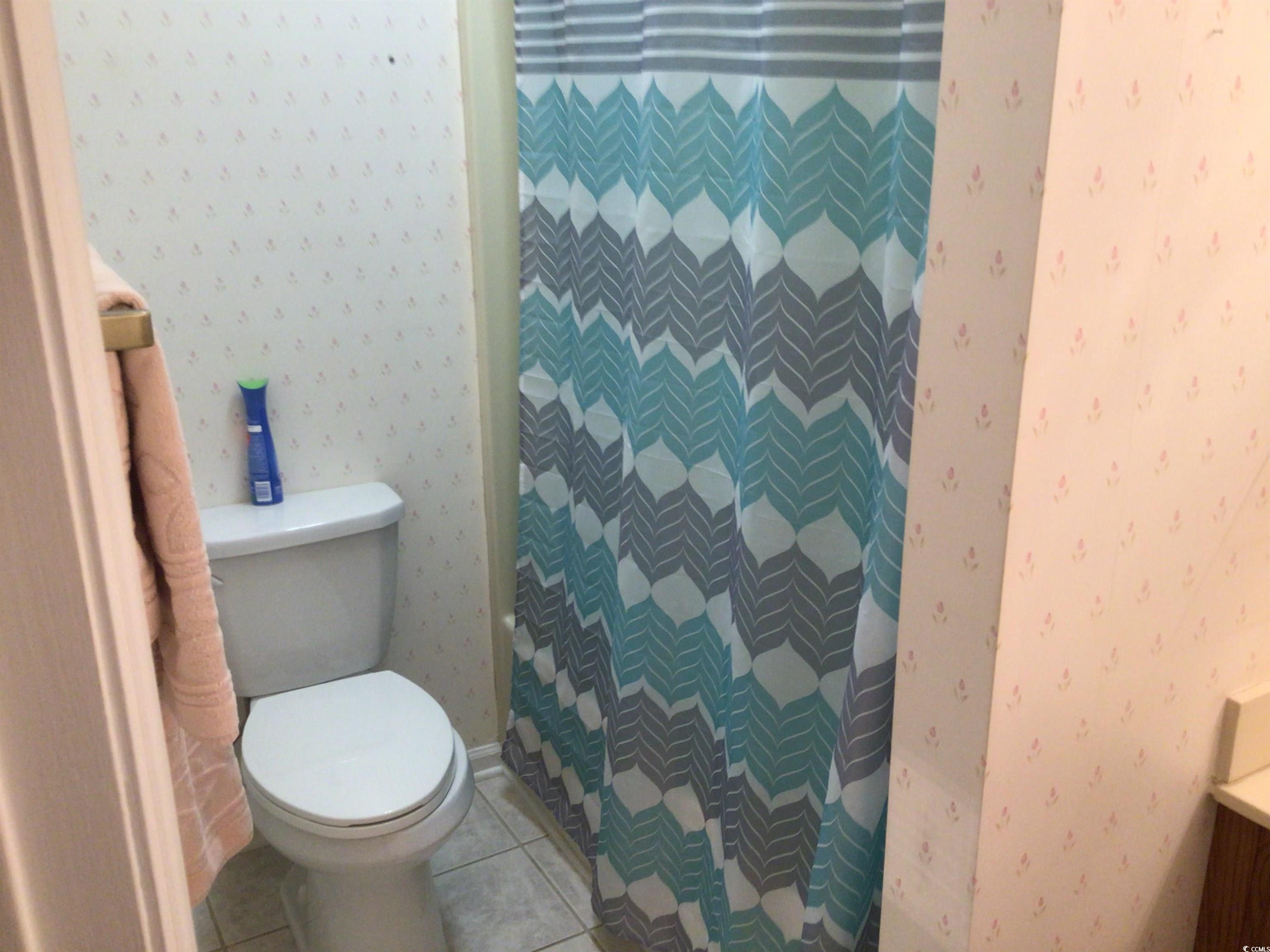 107 Myrtle Trace Drive Conway, SC 29526 - Photo 27 of 31 Bathroom with wallpapered walls, tile patterned flooring, a shower stall, and vanity