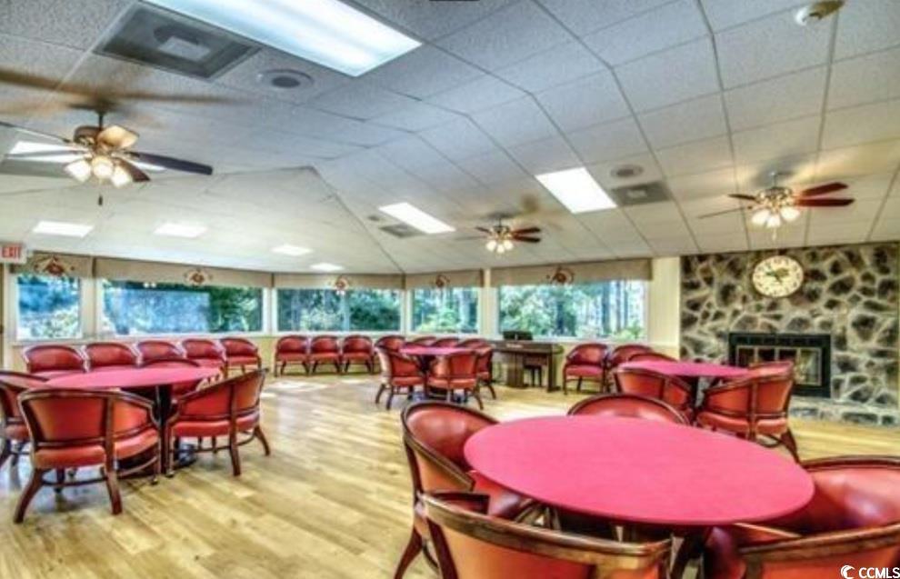 107 Myrtle Trace Drive Conway, SC 29526 - Photo 29 of 31 Dining area featuring a ceiling fan, wood finished floors, a drop ceiling, and a fireplace