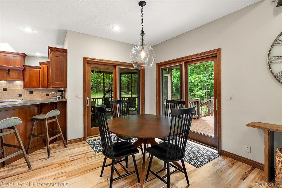 9867 Rainbow Ridge Drive Schoolcraft, MI 49087 - Photo 20 of 82 Dining area featuring wood-finish flooring and two sets of sliding glass doors