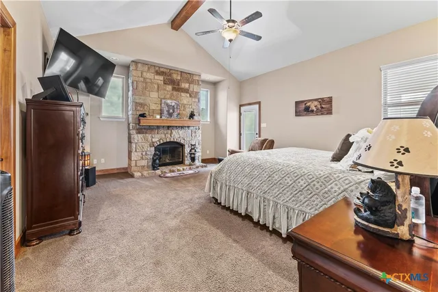 a bedroom with a bed and a fireplace