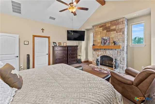 a bedroom with a bed and a fireplace