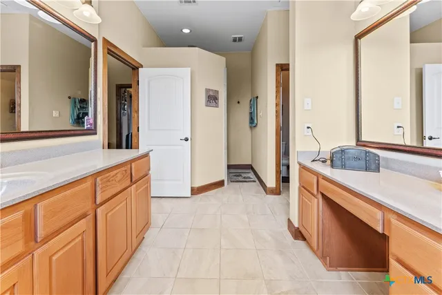 a large bathroom with a granite countertop double vanity sink and a mirror