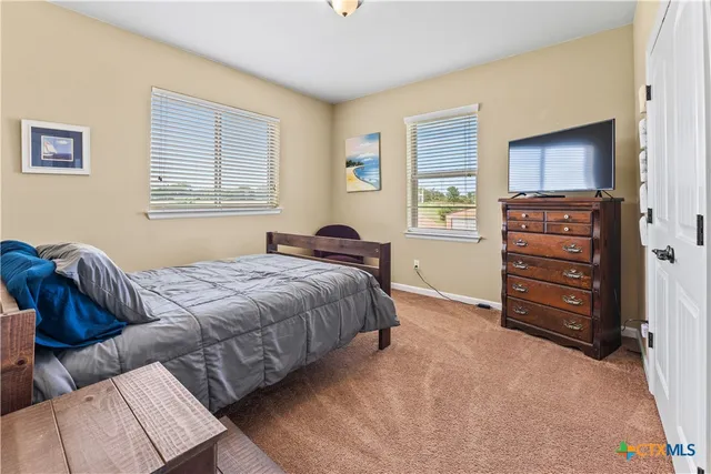 a bedroom with furniture and a window
