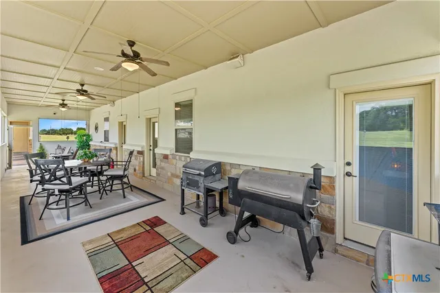 a living room with furniture and a dining table with rug