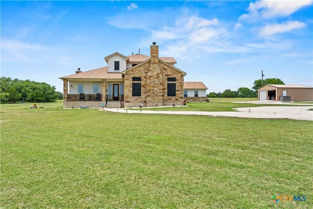 a front view of a house with a big yard