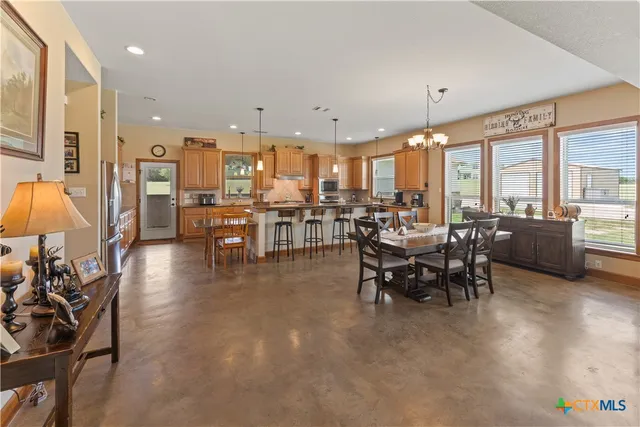 a view of a dining room with furniture window and outside view