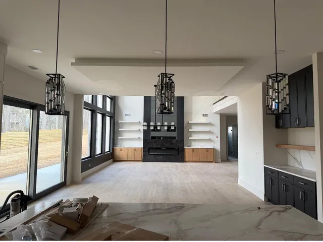 a living room with furniture and a chandelier