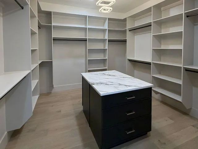 a kitchen with a wooden floor and cabinets