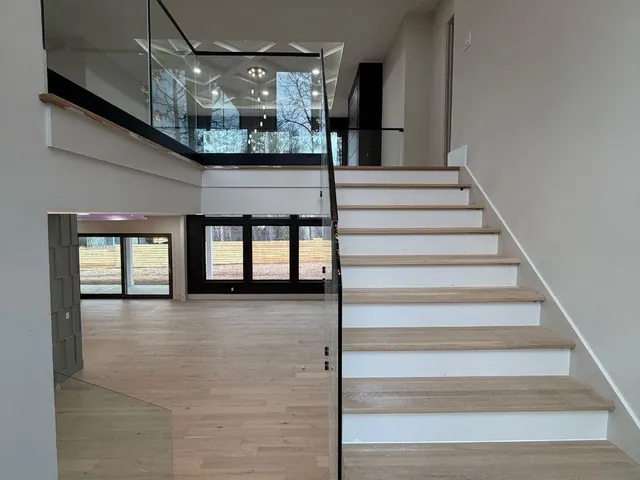 a view of entryway and hall with wooden floor