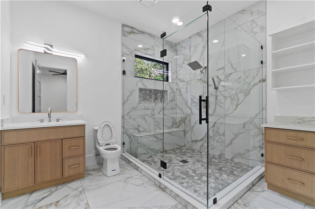 2701 Collins Hill Road Lawrenceville, GA 30043 - Photo 46 of 67 a bathroom with a shower a mirror and a sink