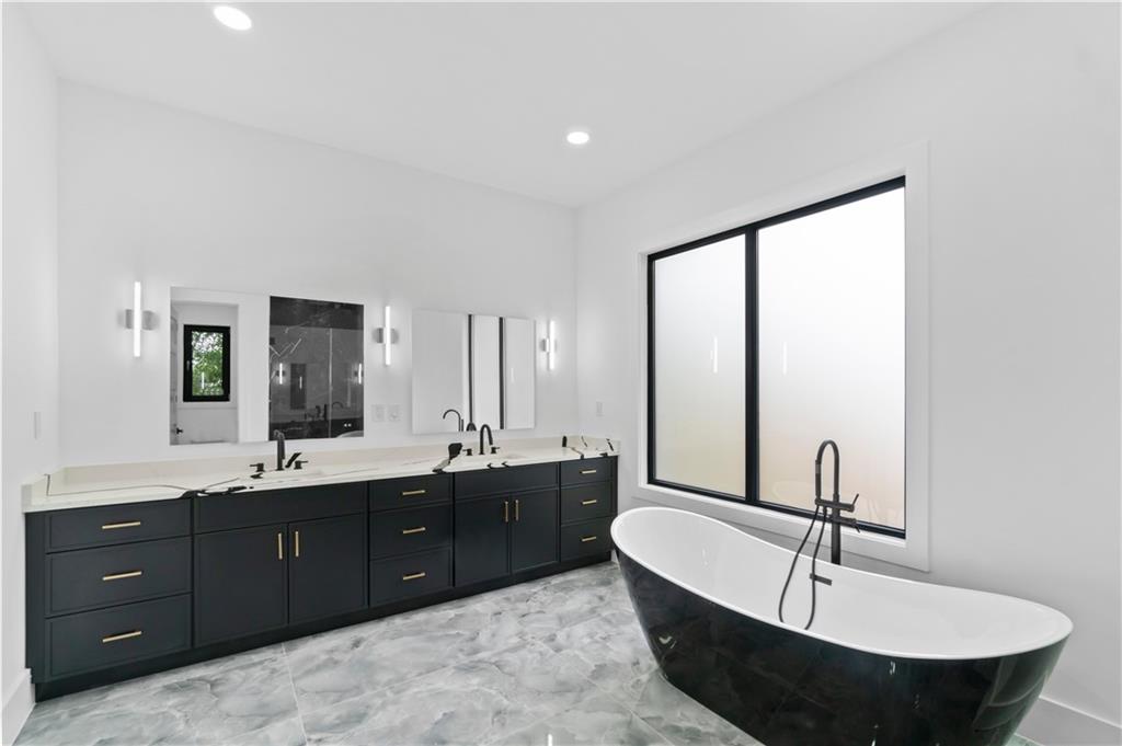 2701 Collins Hill Road Lawrenceville, GA 30043 - Photo 56 of 67 a bathroom with a double vanity sink and mirror