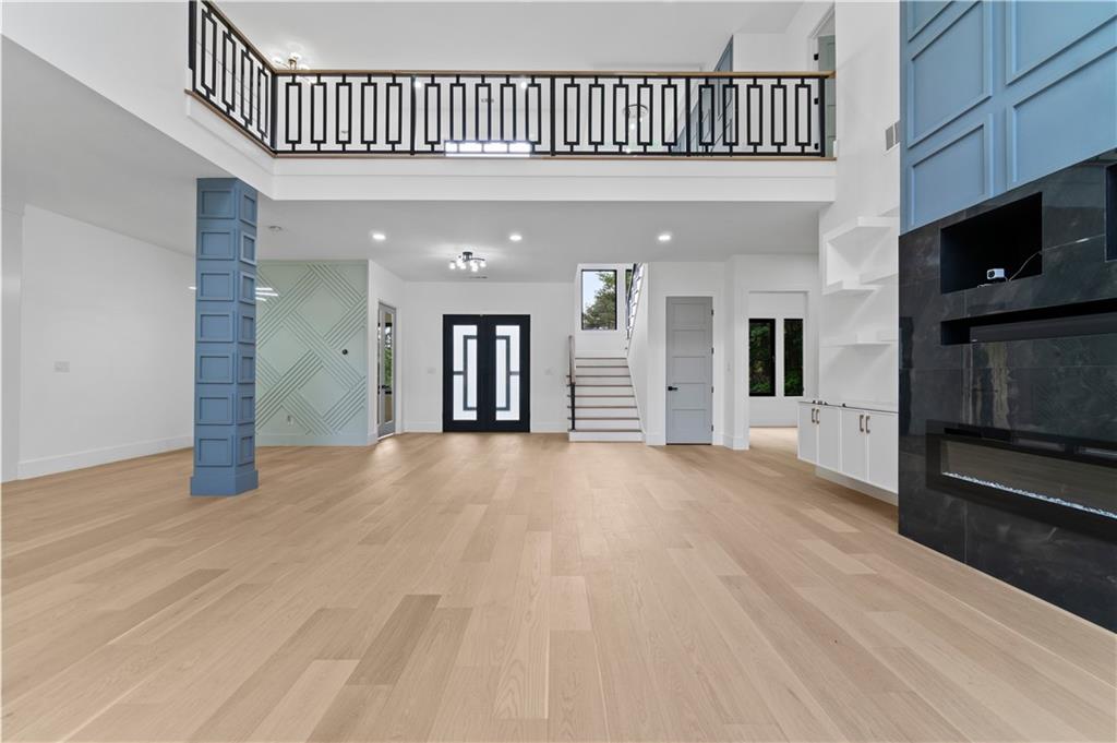 2701 Collins Hill Road Lawrenceville, GA 30043 - Photo 7 of 67 a view of a livingroom with a flat screen tv staircase and a kitchen space
