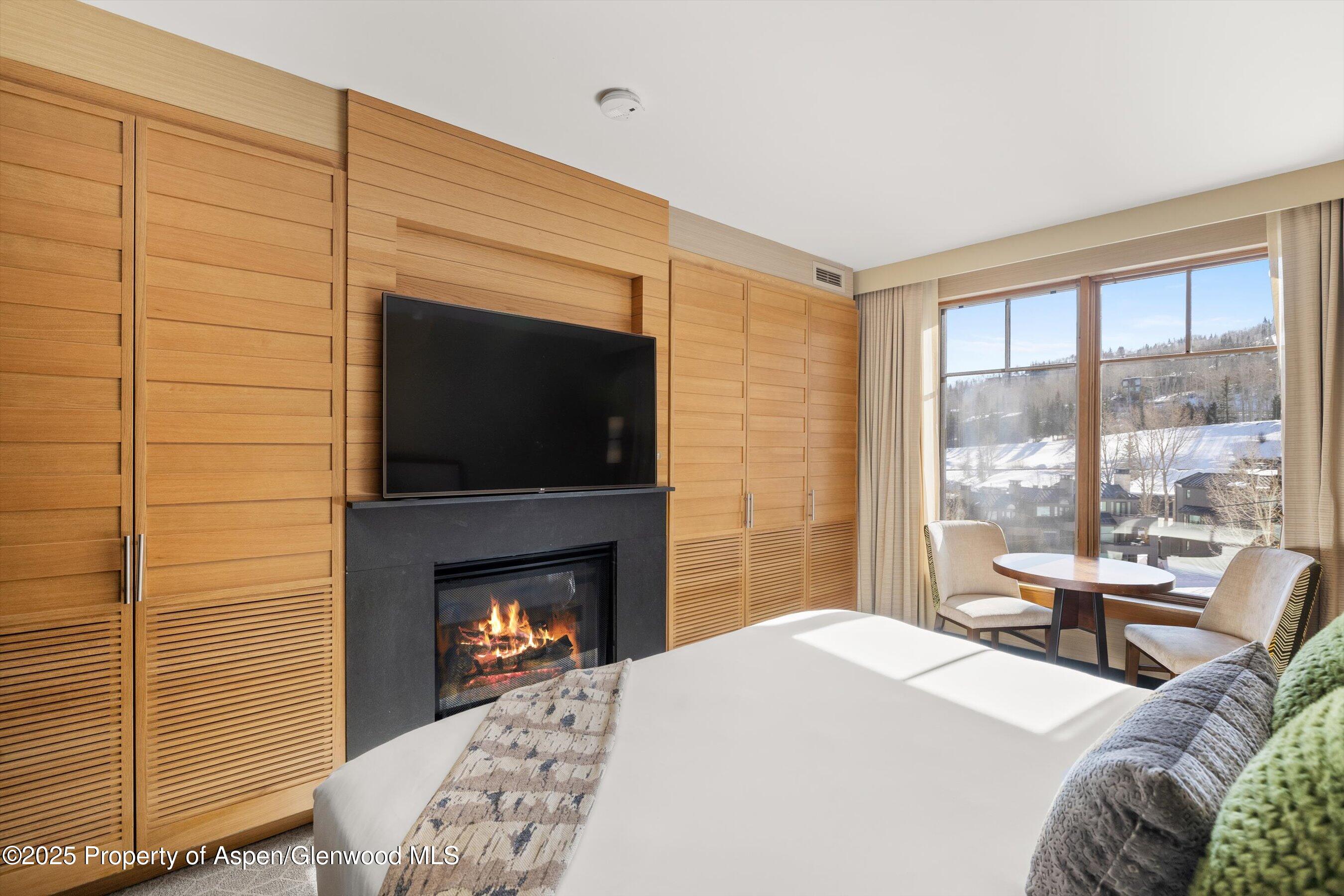 130 Wood Road, Unit 536 Snowmass Village, CO 81615 - Photo 2 of 13 a bedroom with a bed and a fireplace