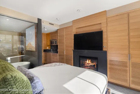 a bedroom with a bed and a fireplace