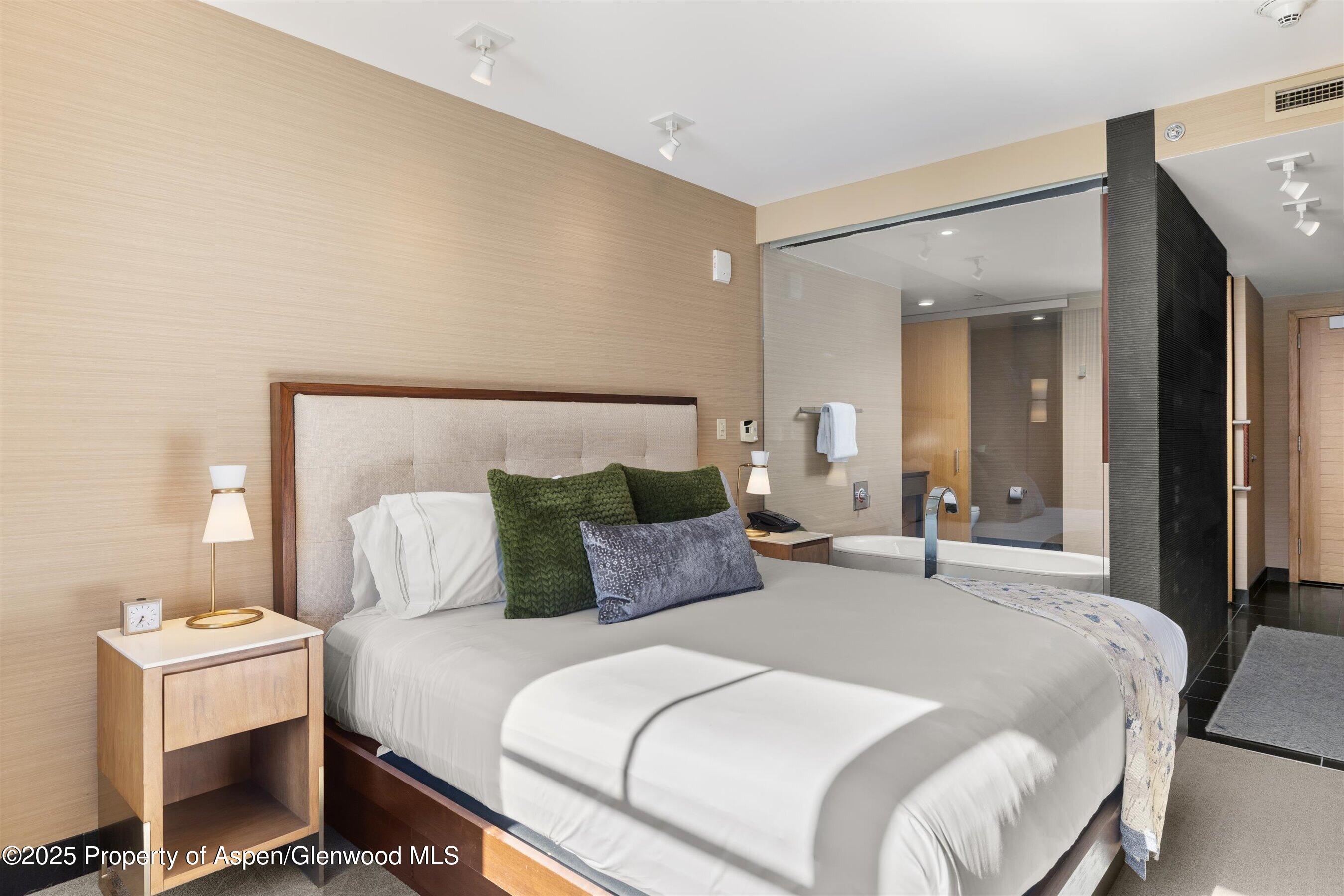 130 Wood Road, Unit 536 Snowmass Village, CO 81615 - Photo 5 of 13 a bedroom with a bed and a mirror