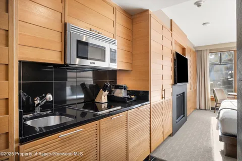 a kitchen with granite countertop a sink and a stove