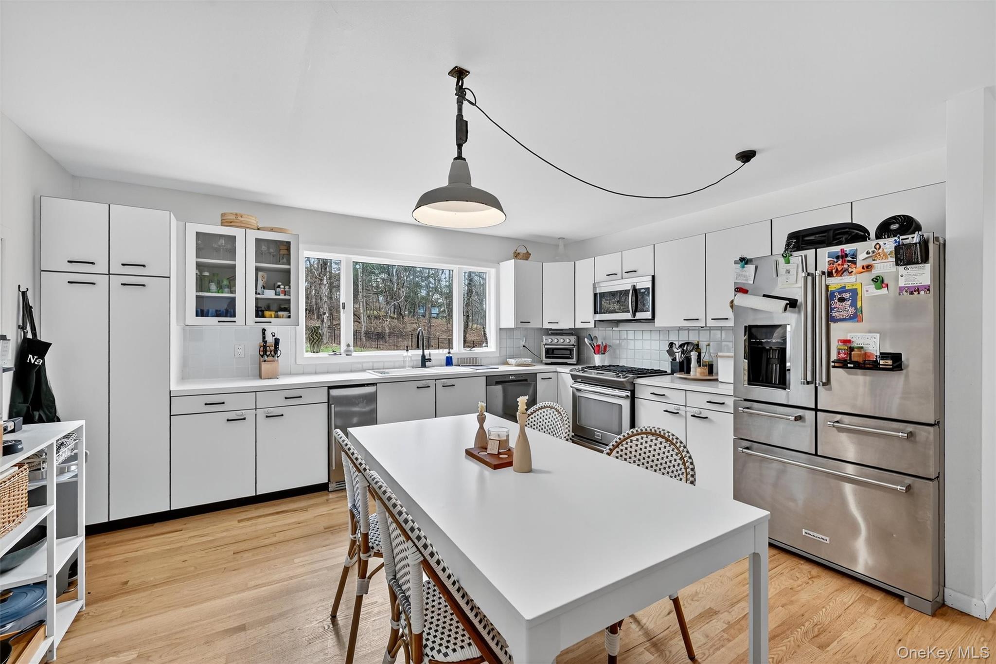 16 Oxford Springs Road Chester, NY 10918 - Photo 13 of 48 a kitchen with granite countertop stainless steel appliances a sink a stove a refrigerator cabinets and dining table