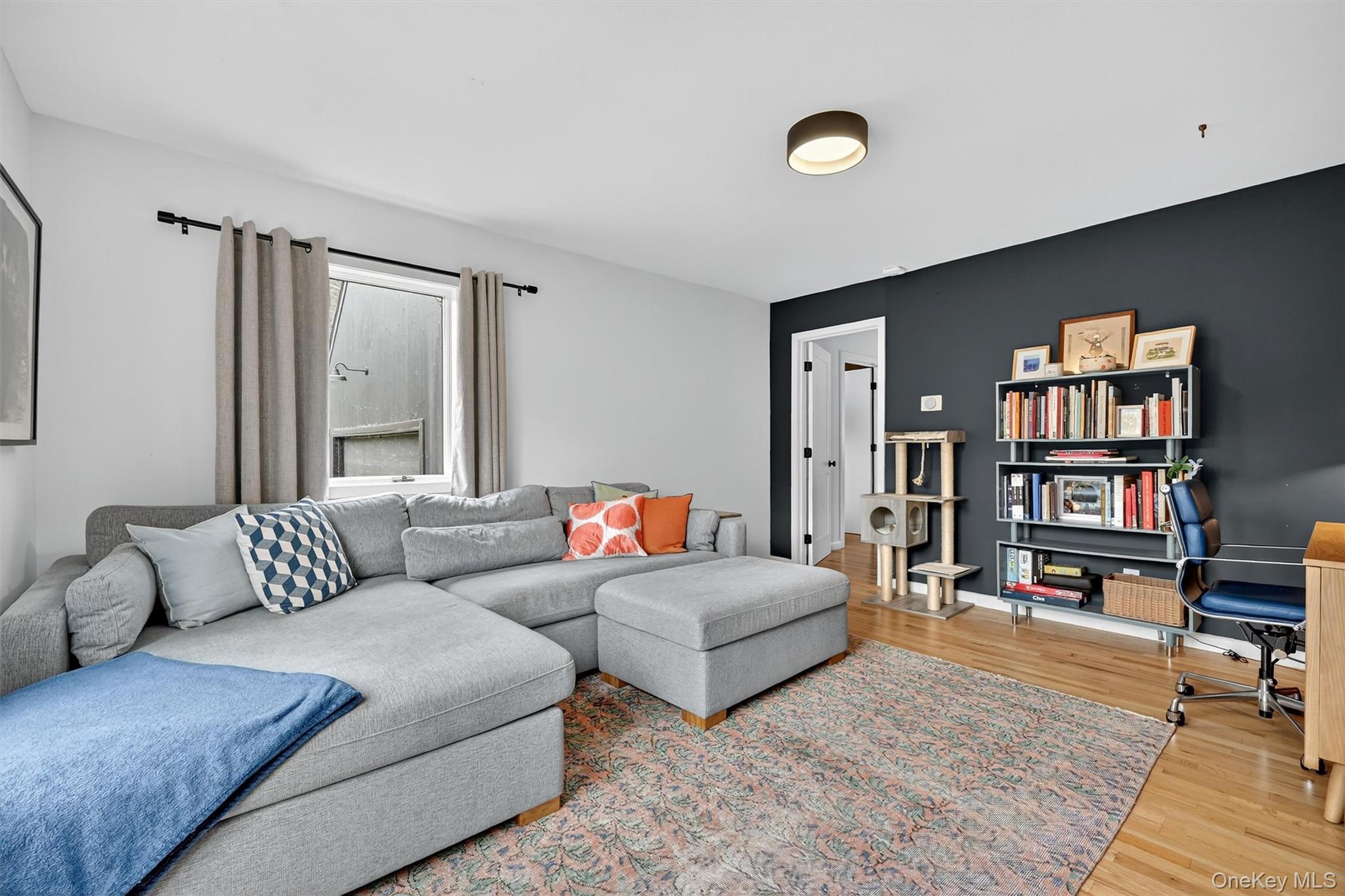 16 Oxford Springs Road Chester, NY 10918 - Photo 19 of 48 a living room with furniture and a book shelf