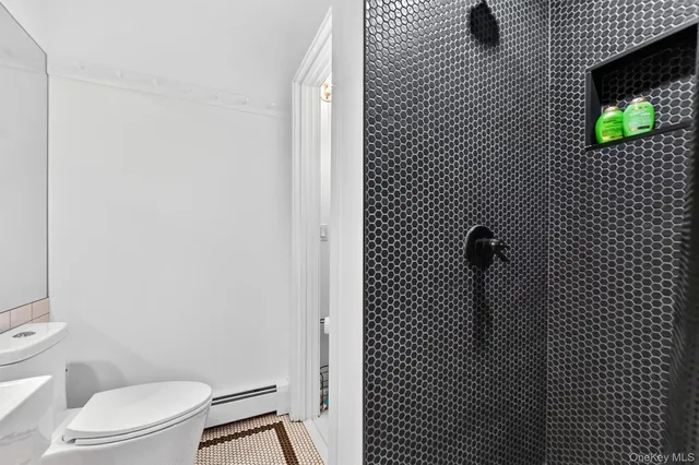 a bathroom with a toilet and a shower