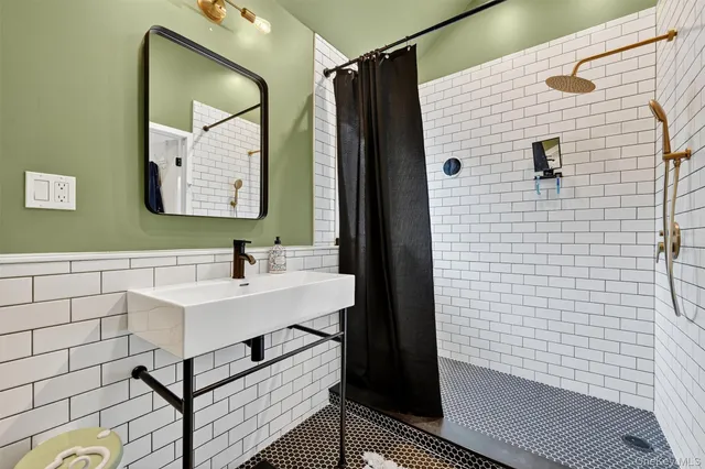 a spacious bedroom with a bed and wooden floor