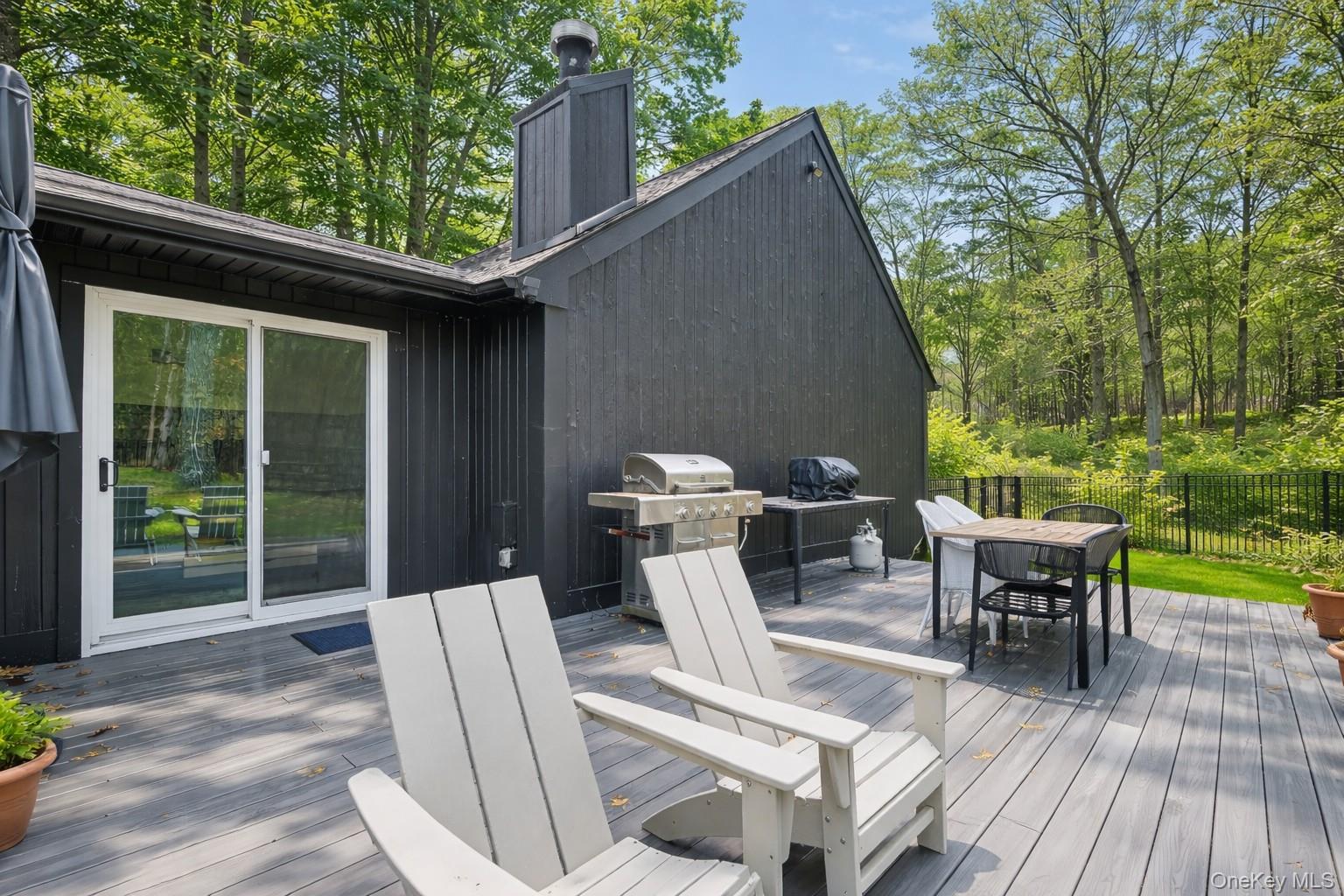 16 Oxford Springs Road Chester, NY 10918 - Photo 34 of 43 a view of a patio with a dining table and chairs with wooden floor and fence