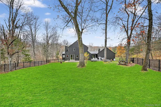 an aerial view of a house with a yard basket ball court and outdoor seating
