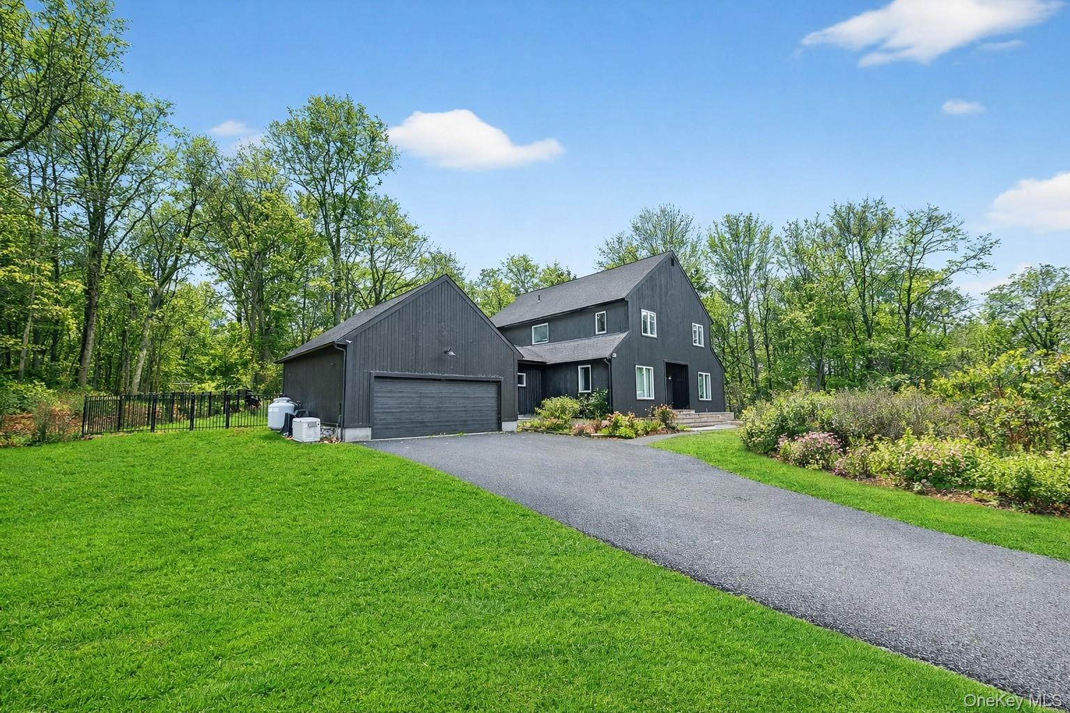 16 Oxford Springs Road Chester, NY 10918 - Photo 41 of 43 a front view of a house with a garden and trees