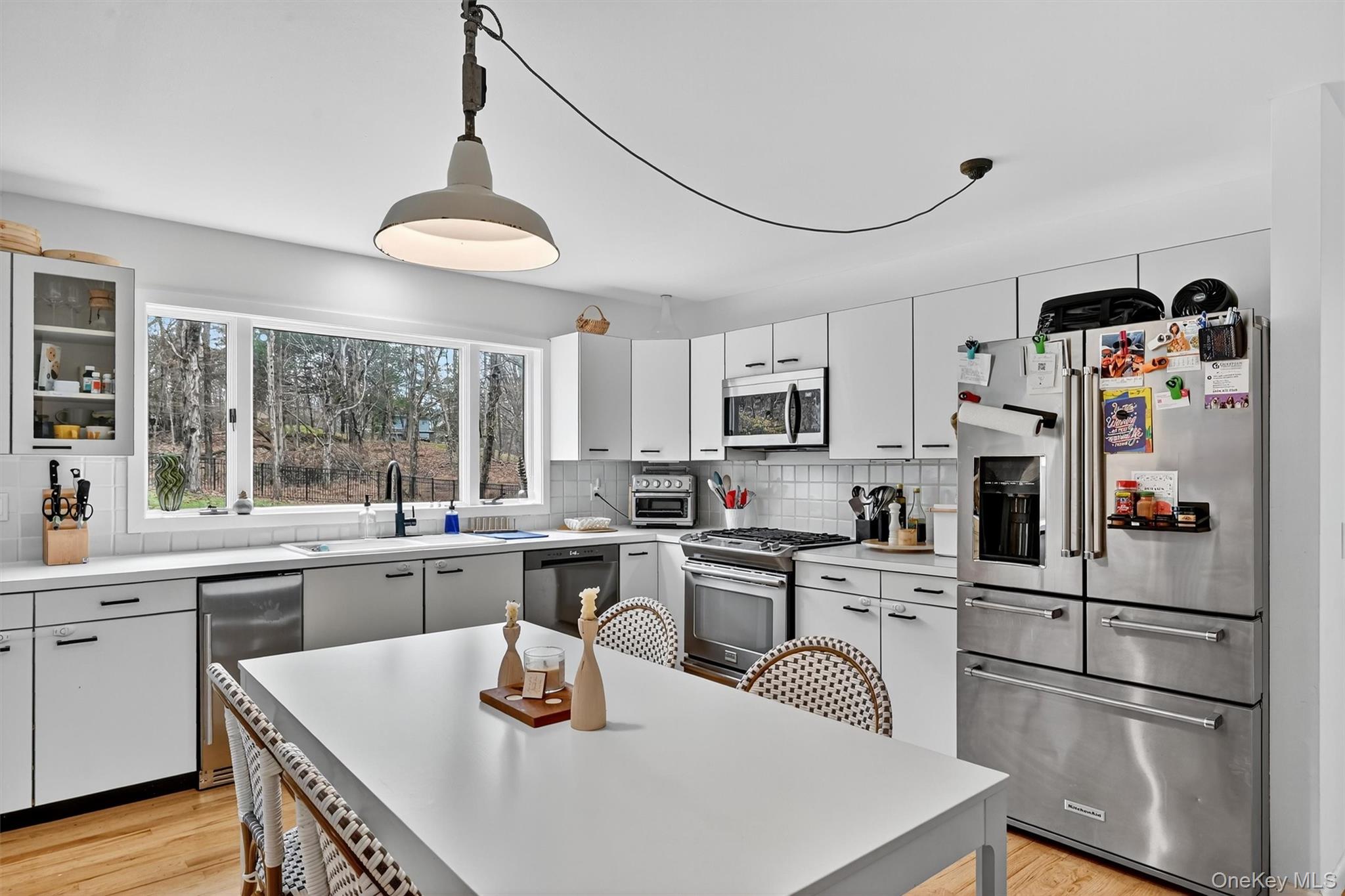 16 Oxford Springs Road Chester, NY 10918 - Photo 7 of 48 a kitchen with granite countertop a refrigerator a stove a sink dishwasher and white cabinets with wooden floor
