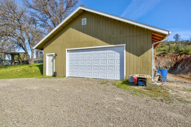 a view of a house with a yard and garage