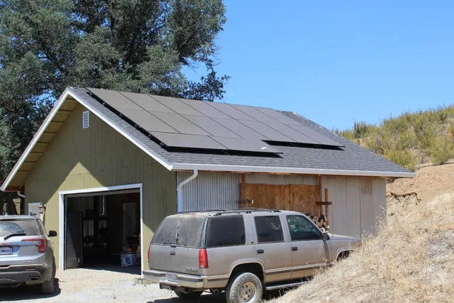 a kitchen with stainless steel appliances granite countertop a stove a refrigerator a kitchen island a dining table and chairs