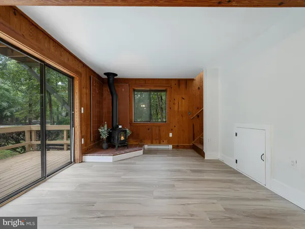 a view of a room with wooden floor and furniture