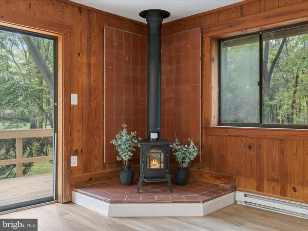 a view of a dining room with wooden floor and a potted plant