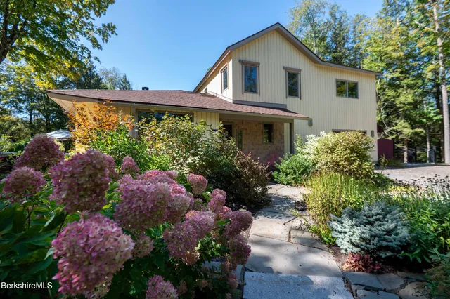 a view of a house with a yard and plants