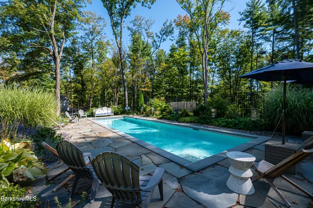a view of a backyard with sitting area furniture and garden
