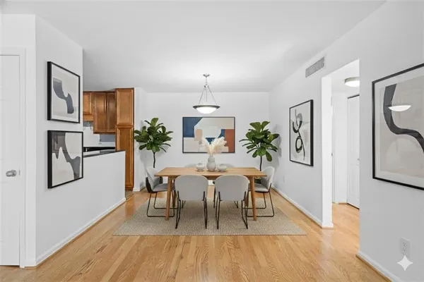 a view of a dining room with furniture and wooden floor