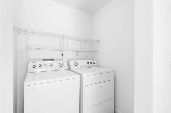 a view of storage and utility room with washer and dryer