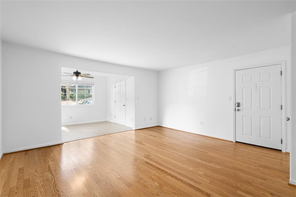 1468 Briarwood Road Northeast, Unit 602 Atlanta, GA 30319 - Photo 4 of 30 a view of an empty room with wooden floor and a window
